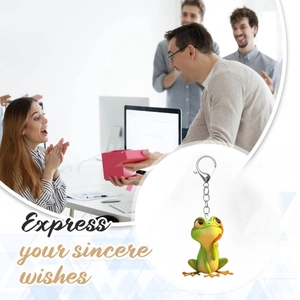 Close-up of cute cartoon frog acrylic keychain with metal clip for creative holiday gifts
