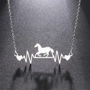 Detailed view of silver heartbeat necklace with galloping horse and heart silhouette
