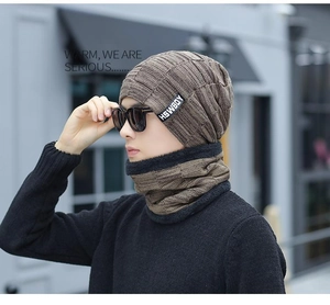 Detail of men's thick knit dark brown winter beanie and scarf set with soft lining