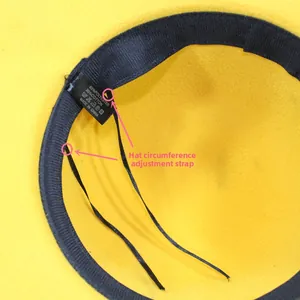 Detail view of the yellow wool hat interior showing adjustable strap and brand labels