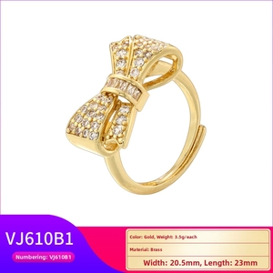 Close-up of gold brass bow ring with sparkling cubic zirconia and detailed size parameters