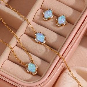 Detail of 18K gold plated jewelry set with blue opal stones in a pink velvet box