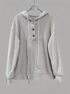 Close-up of light gray ribbed knit hoodie featuring three decorative wooden buttons at neck