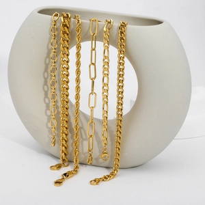 Detailed set of 6 golden chains including Cuban and Figaro styles on a ceramic ring