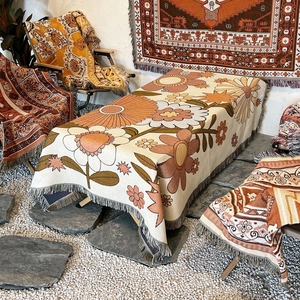 Bohemian style woven camping blanket with retro floral patterns and fringe details