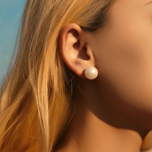 Elegant 925 sterling silver stud earrings with 12mm white pearl on female model