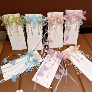 Macro view of floral hair clips with ribbon tassels and pearls in various pastel colors