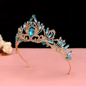 Detailed view of Baroque gold crown featuring light blue crystals and floral metalwork