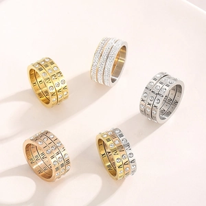 Detail of stacked stainless steel rings with Roman numerals and pavé cubic zirconia