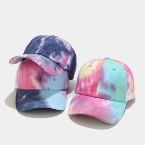 Detailed view showing three tie-dye baseball caps with vibrant patterns and six-panel design