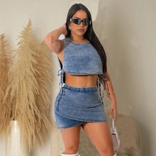 Detail of blue denim two-piece set featuring a cropped vest and asymmetric mini skirt