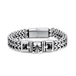 Detail of men's punk skull bracelet with woven chain and vintage oxidized finish