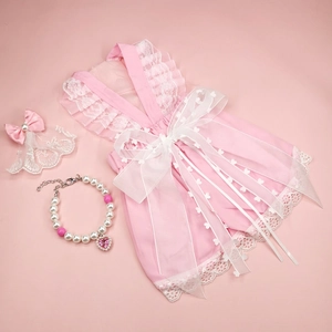 Detailed pink pet dress set with lace ruffles, pearl necklace, and heart hair clip