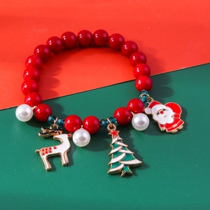 Detail of Christmas beaded bracelet with Santa Claus and reindeer enamel charms