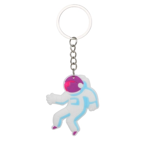 Cute white astronaut keychain with blue and purple accents on a simple white background