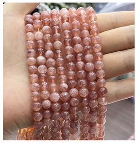 Macro shot of natural pink strawberry quartz round beads for DIY jewelry making