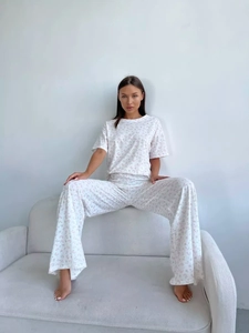 Detail of floral print pattern on cream short sleeve pajama set with wide leg trousers