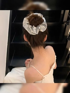 French style metallic silver scrunchie worn by a model on hair with a sleek finish