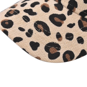 Close-up of leopard print corduroy baseball cap with fine stitching and textured fabric