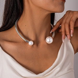 Macro view of silver spiral textured neck cuff with elegant faux pearl details