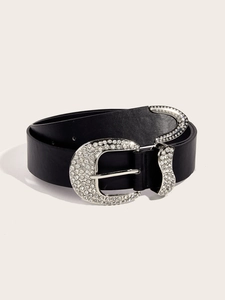 Close-up of black leather belt with sparkling rhinestone buckle and horseshoe metal tip