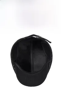 Close-up of winter flat cap with thick black fleece lining and side adjustment buckle