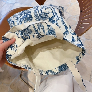 French vintage floral canvas tote bag with inner pocket on a wooden chair
