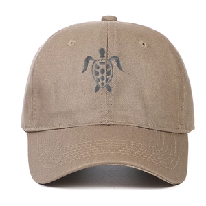Detailed close-up of khaki cotton baseball cap featuring high-quality grey turtle embroidery