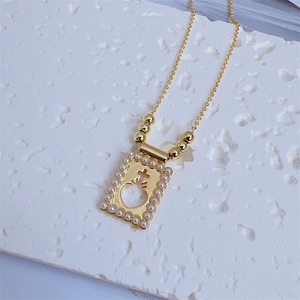 18K gold-plated necklace featuring a pearl-framed hollow heart and cross pendant