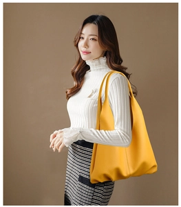 Yellow leather tote bag with lychee texture shown on model for daily office commute