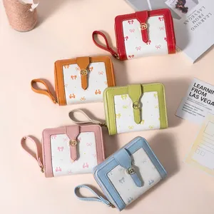 Short women's bow wallets in red, orange, green, pink, and sky blue with gold metal buckles