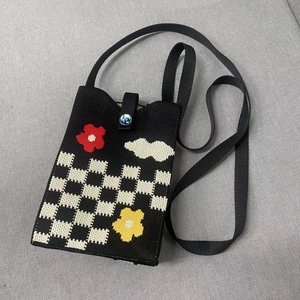 Fashionable black and white checkerboard knit crossbody phone bag with floral patterns
