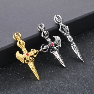 Detailed view of three creative titanium steel Vajra pendants in gold and silver finishes