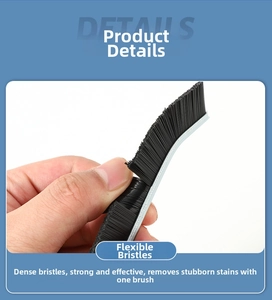 Detail showing dense flexible black bristles and curved head of the tile gap cleaning brush