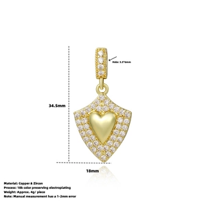 Detail view of 18k gold plated heart shield charm with zircon inlays and dimensions