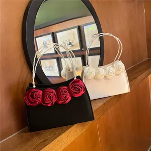 Detail of vintage satin evening bags with 3D roses and pearl beaded handles