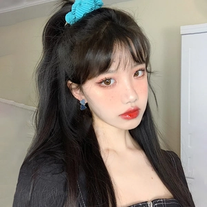 Elegant denim blue heart-shaped earrings on model with matching blue scrunchie