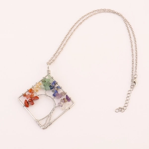 Handmade tree of life necklace featuring square pendant with colorful chakra stones.