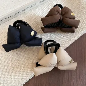 Three-piece acrylic bow shark clips in black, brown and beige colors for elegant hair styling