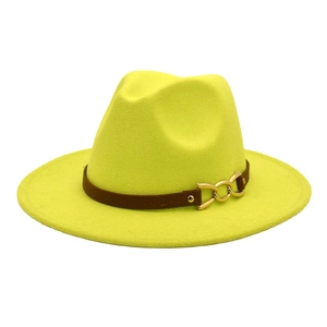 Detailed shot of yellow wool fedora featuring a brown leather band and gold chain buckle