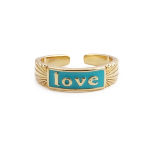 Detailed macro view of gold-plated LOVE ring with teal enamel and sunburst texture