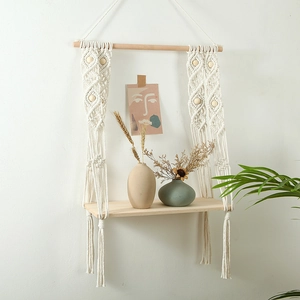 Boho hand-woven cotton tapestry wall shelf featuring decorative wooden beads and a shelf