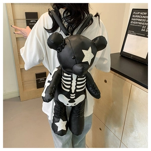 Detail of punk style bear backpack featuring skull bone print and star patch detail