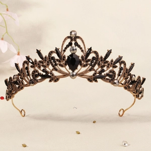 Detailed macro of vintage black rhinestones and bronze leaf design on Gothic bridal crown