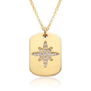 Detail of gold rectangle pendant necklace with starburst motif and micro-set crystals