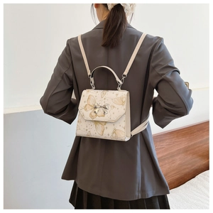 Detailed back view of a woman wearing the white butterfly pattern backpack with thin straps