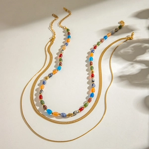Double-layered gold snake chain necklace with colorful natural stone beads in boho style