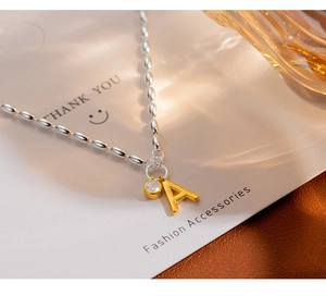 Close-up of S925 silver beaded bracelet with letter A pendant and small zircon stone