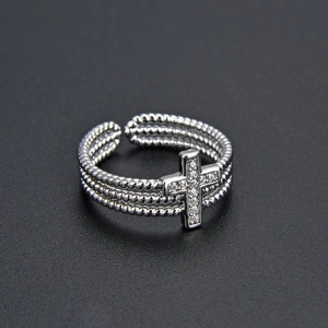 Detail of silver multi-layer ring with sparkling zircon cross and adjustable band