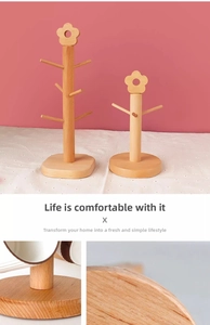 Macro shot of dual-size solid wood jewelry holders with floral top and branch hooks